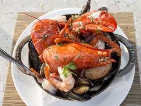 Pot of lobster, clams, and corn